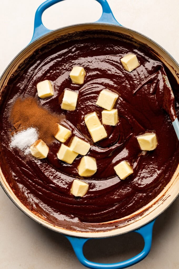 cubed butter in saucepan with chocolate sauce