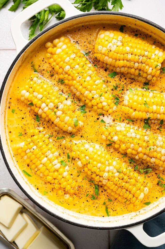 cajun milk-boiled corn on the cob in large white pot