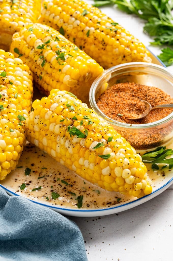 creamy corn on the cob with spices on plate