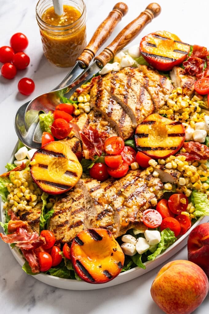 grilled chicken peach salad on platter