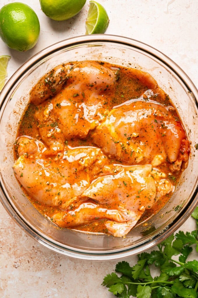 raw marinated chicken in glass bowl