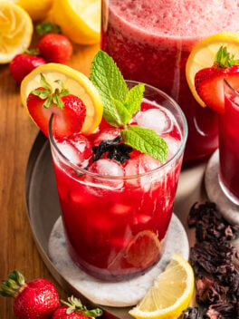 strawberry hibiscus lemonade glass with fresh mint
