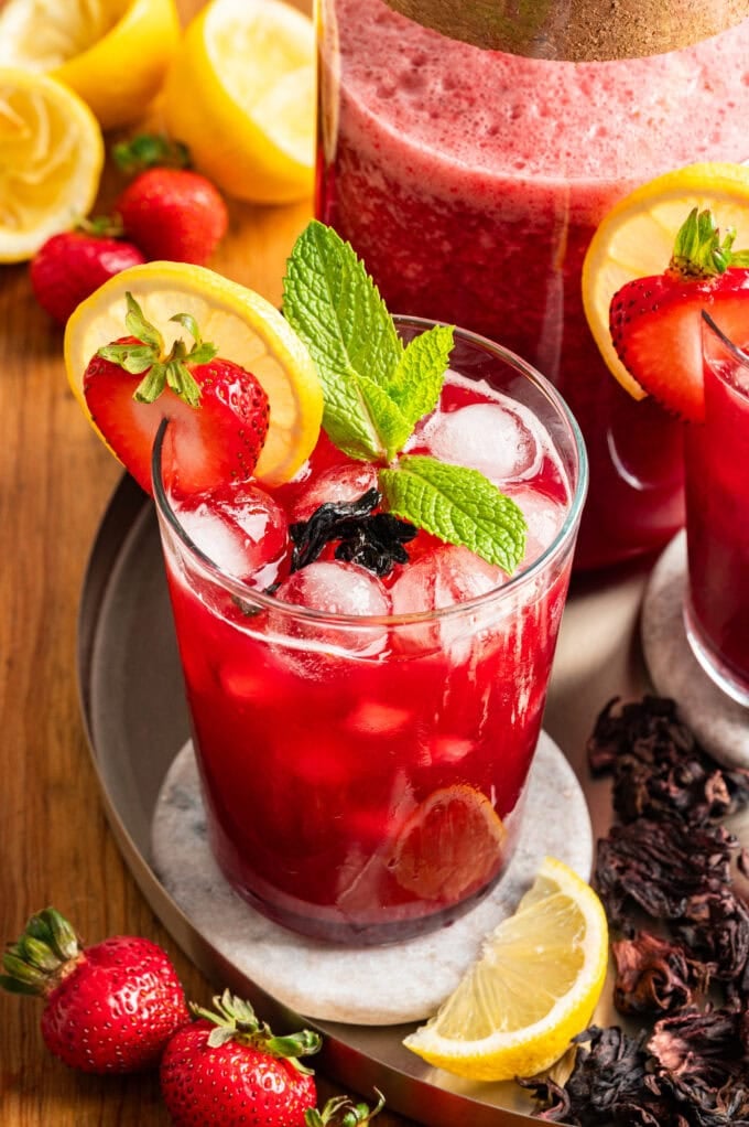 strawberry hibiscus lemonade glass with fresh mint