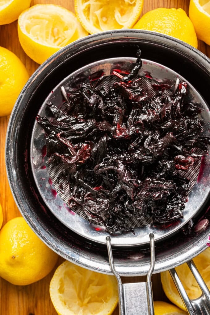 strained hibiscus over saucepan