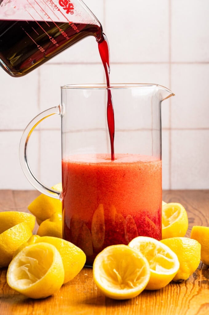 hibiscus syrup being poured into pitcher
