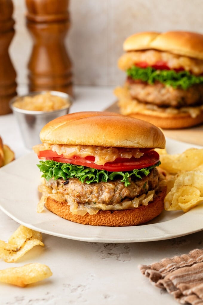 blue cheese turkey burgers with potato chips on white plate