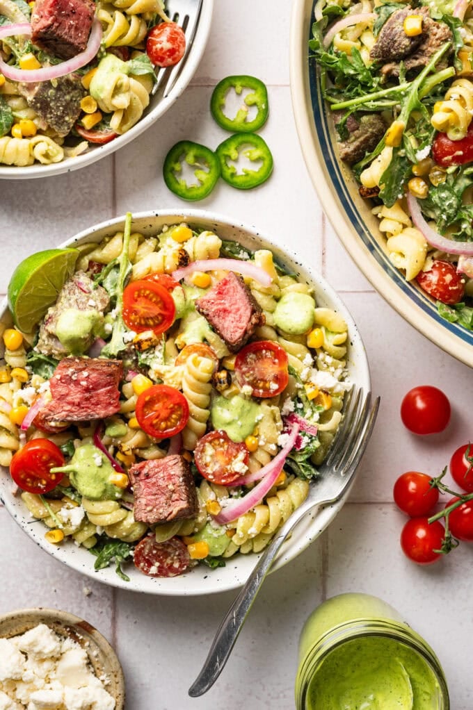 steak pasta salad in bowls