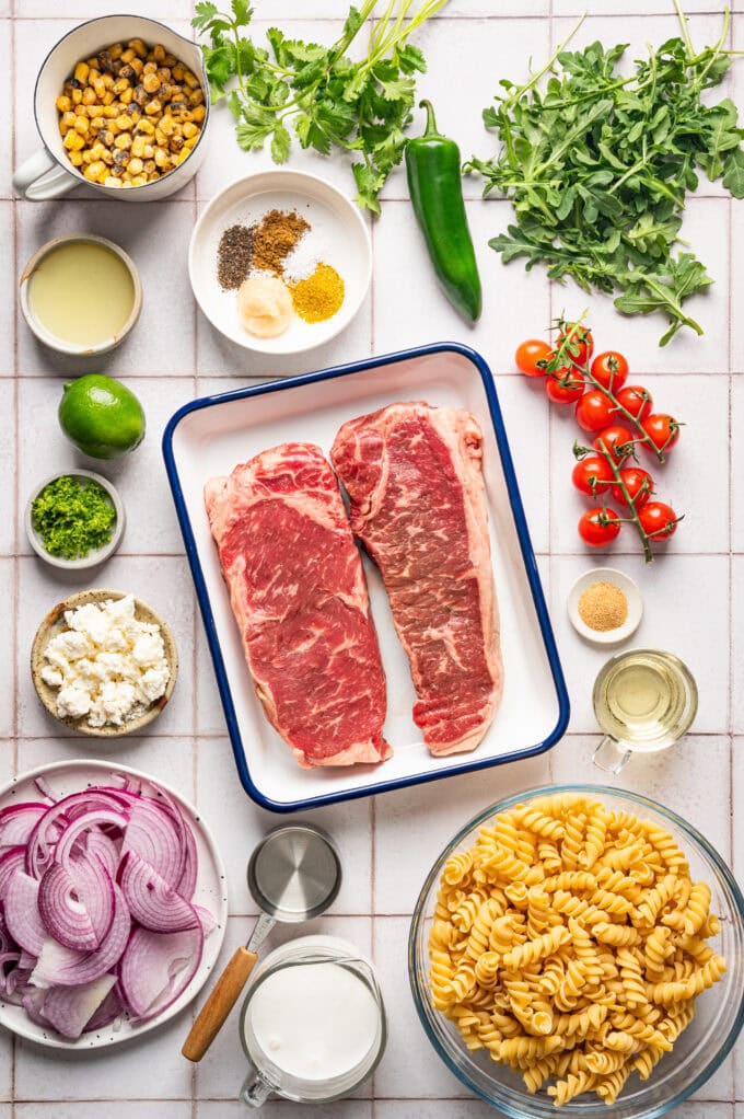 ingredients for high protein steak pasta salad in bowls