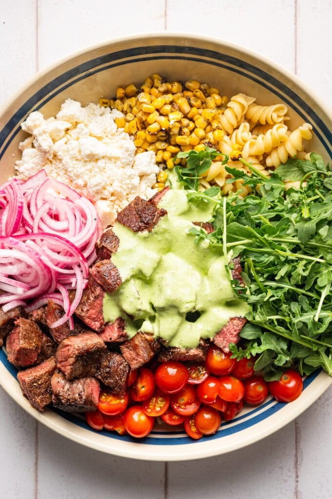 steak pasta salad ingredients in large bowl
