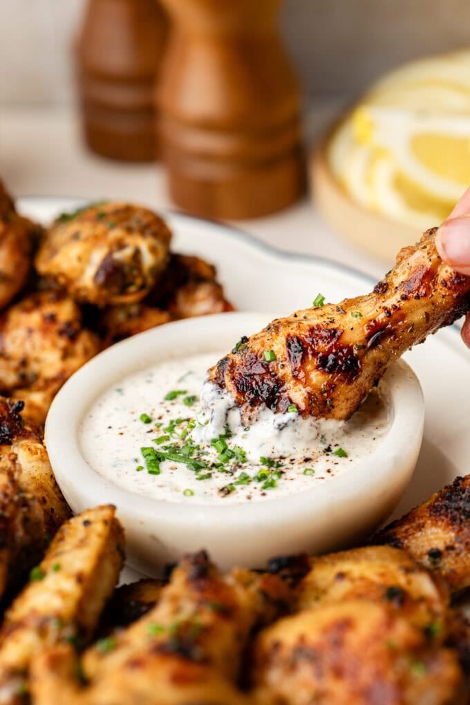 grilled chicken wing in small bowl of jalapeno ranch