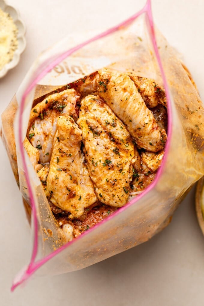 seasoned chicken wings in large plastic bag