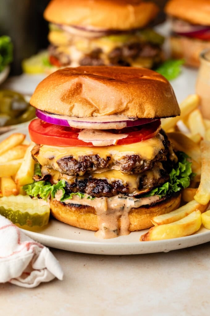 smash burgers on plates with burger sauce
