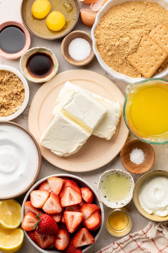 ingredients for vanilla cheesecake bars in small bowls