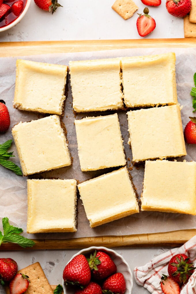 vanilla cheesecake bars on parchment paper