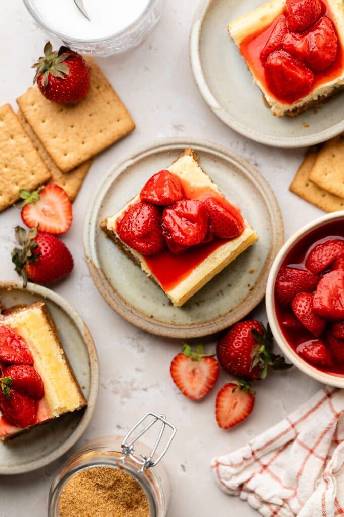 vanilla cheesecake bars with strawberry compote on small plates