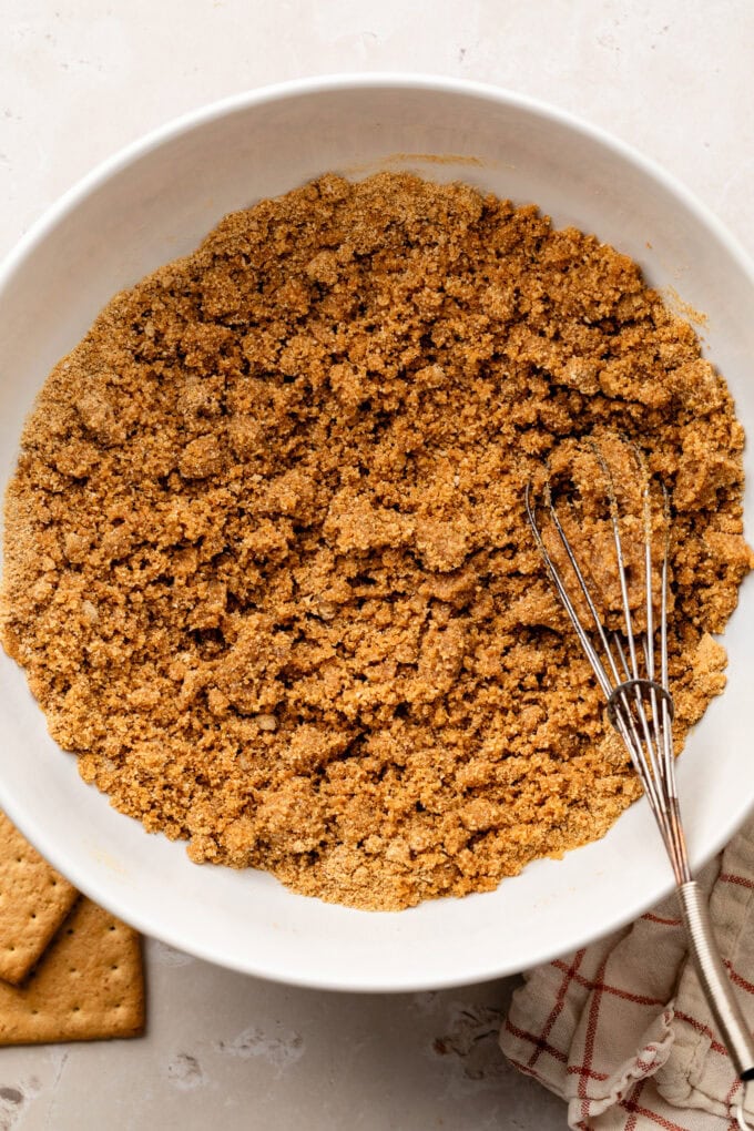 graham cracker crumbs in bowl with whisk