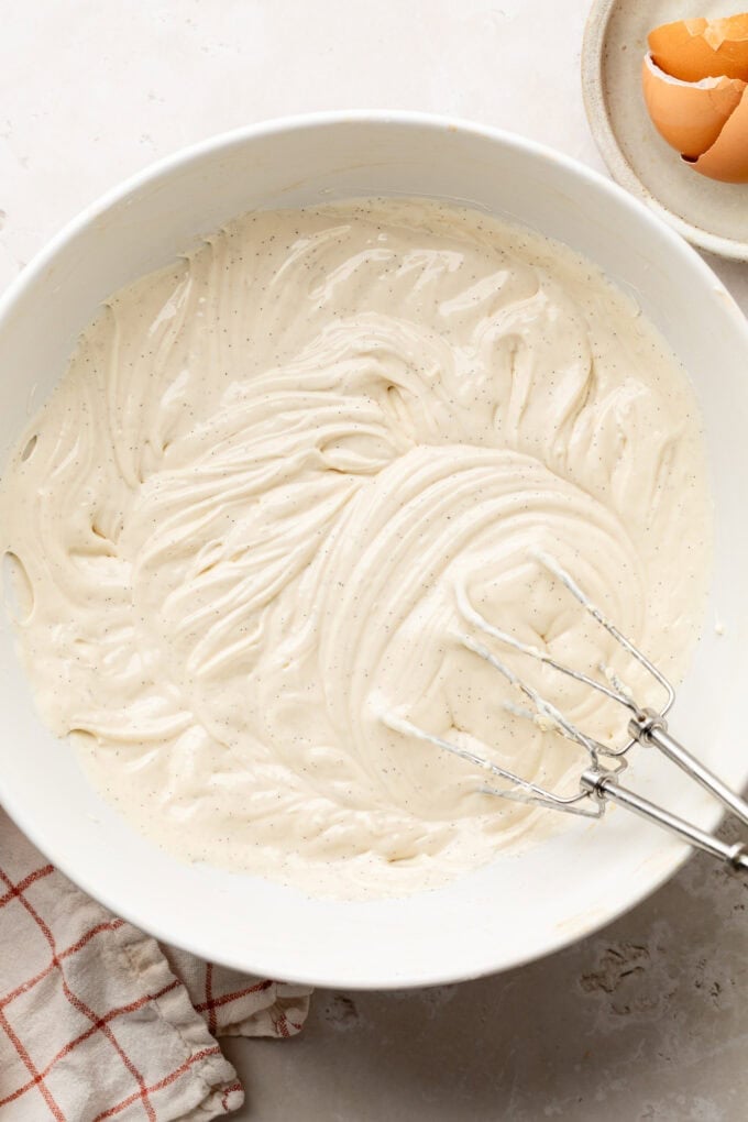 vanilla cheesecake batter in bowl with whisk