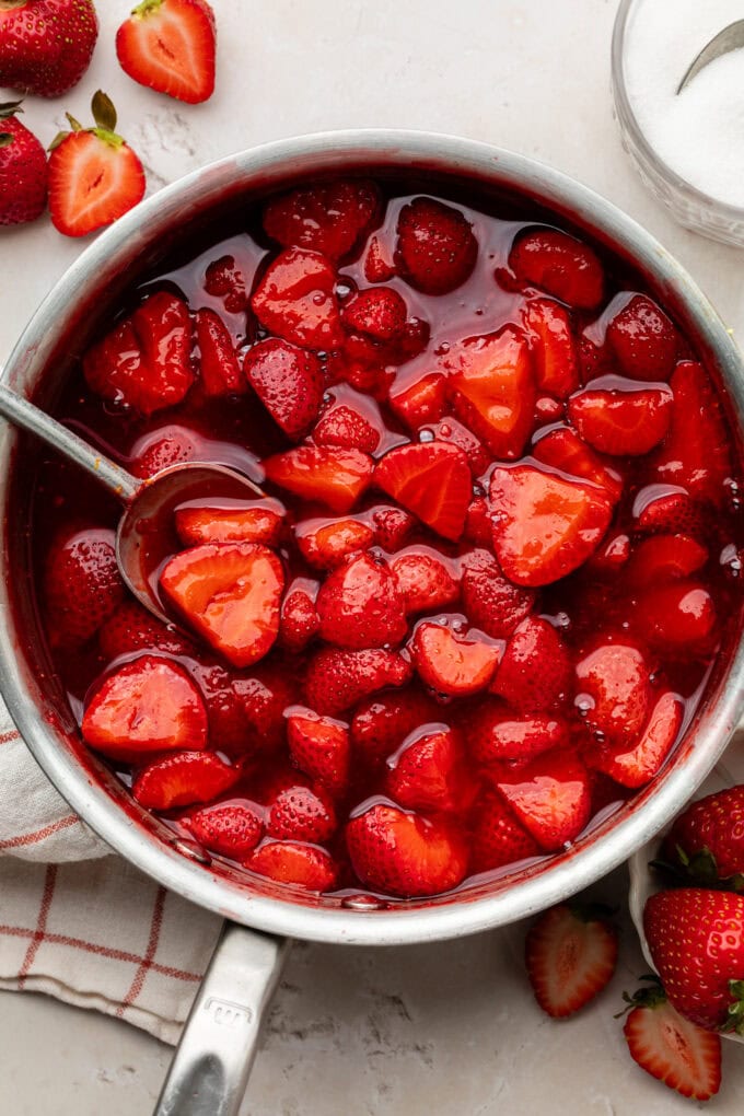 strawberry compote in saucepan with spoon