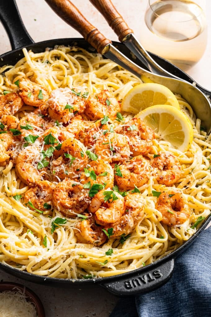 creamy lemon herb pasta with cajun shrimp in skillet