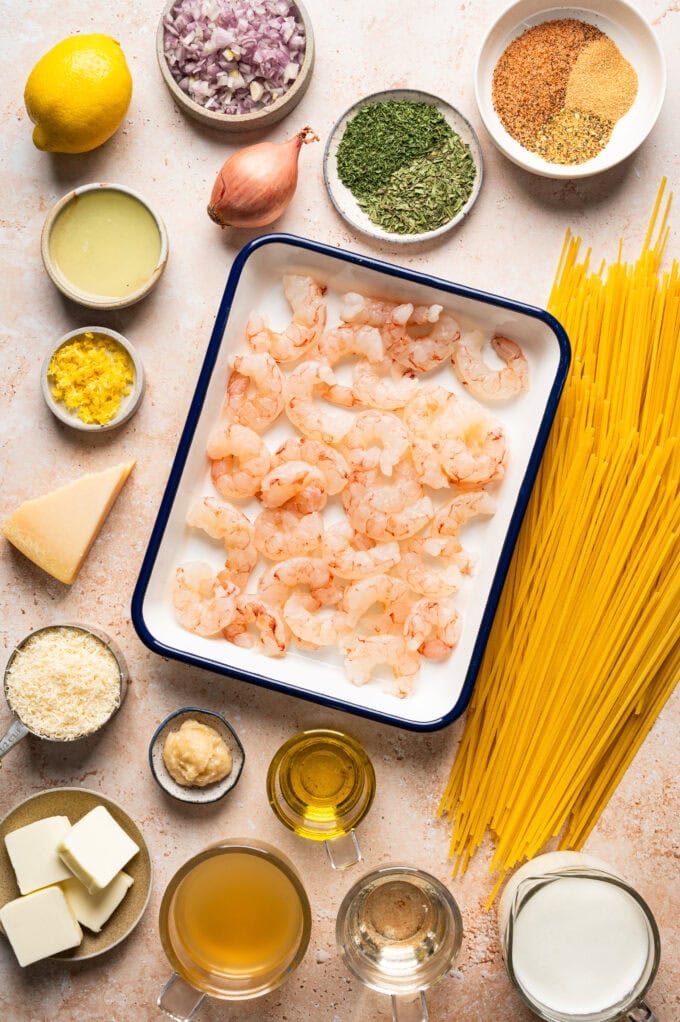 ingredients for creamy lemon herb butter pasta with cajun shrimp in bowls