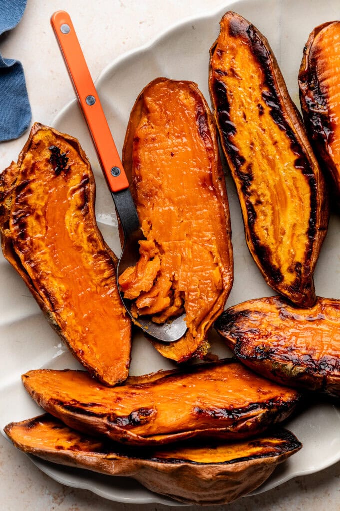 spoon in roasted sweet potato on platter