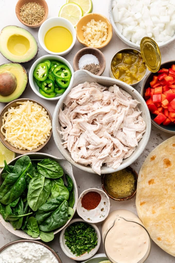 ingredients for spinach chicken enchiladas in bowls