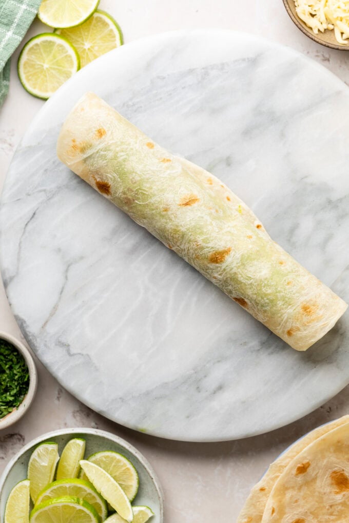 rolled tortilla on marble platter