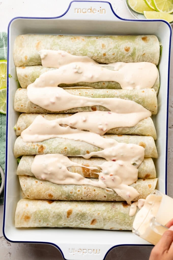 rolled enchiladas with queso in baking pan