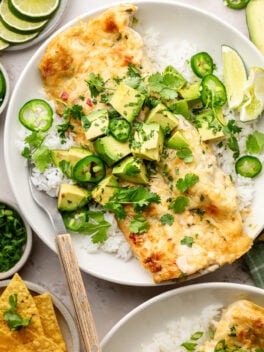 spinach chicken enchiladas on plate with fork