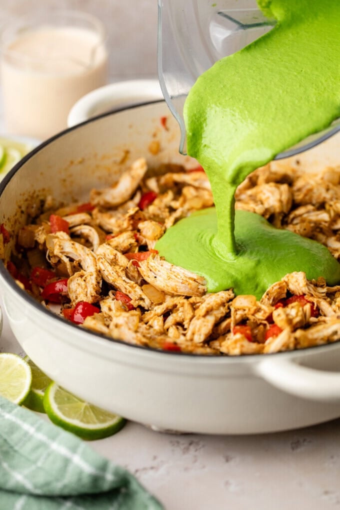 cottage cheese and spinach mixture being poured into skillet
