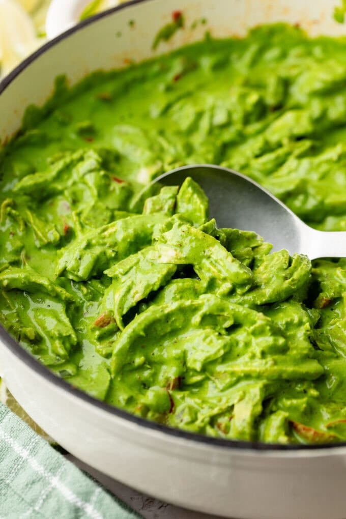 spinach chicken mixture in skillet with spoon