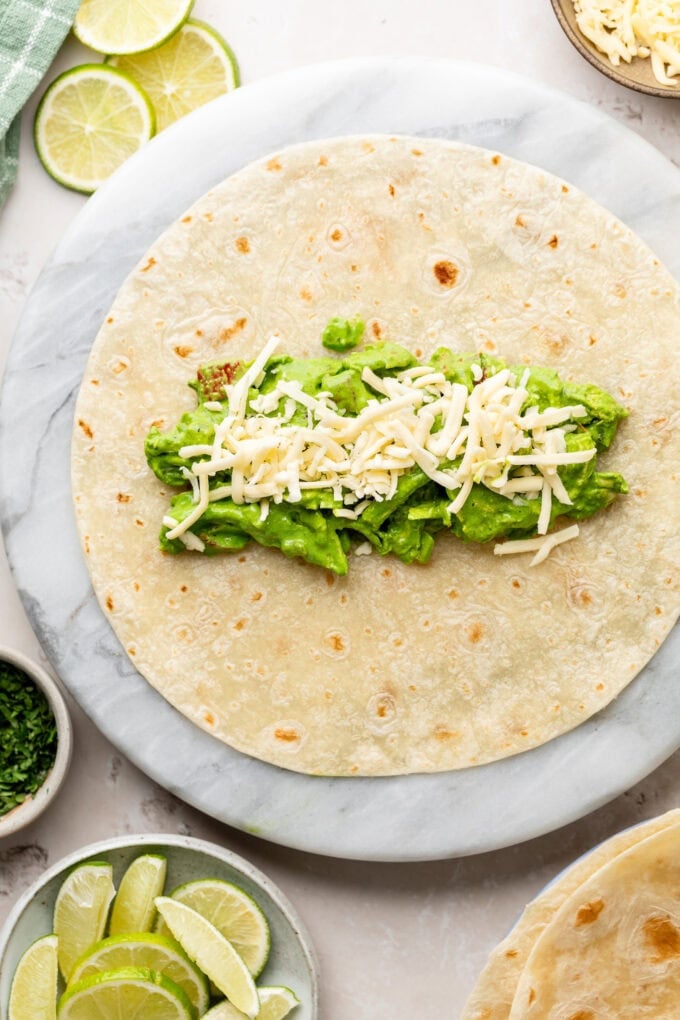 spinach chicken mixture with cheese on tortilla