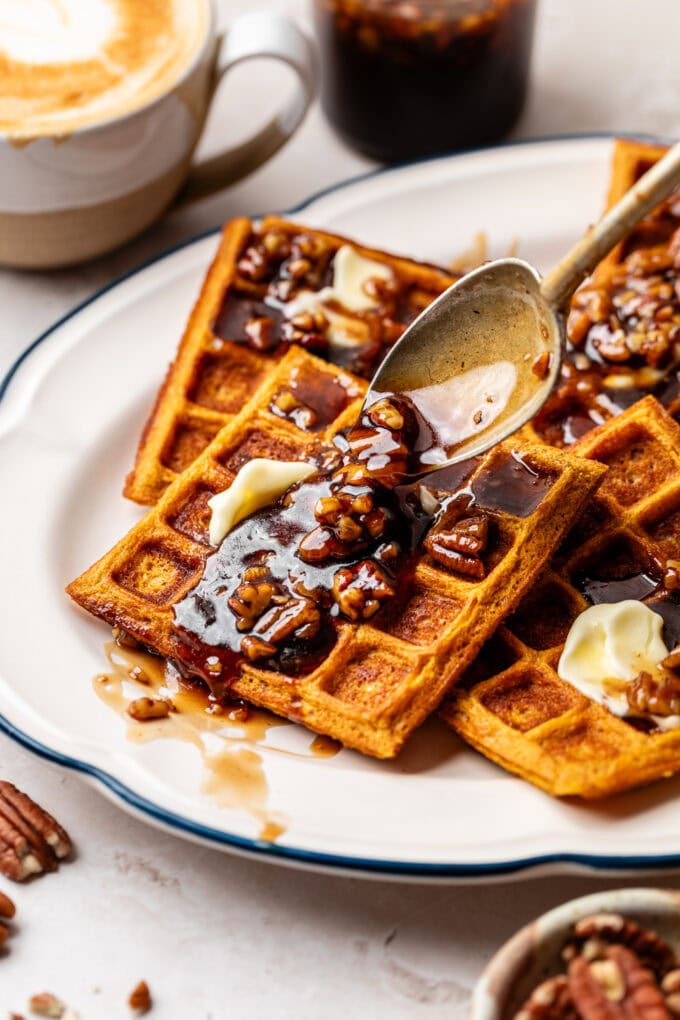 butter pecan syrup being poured onto sweet potato waffles