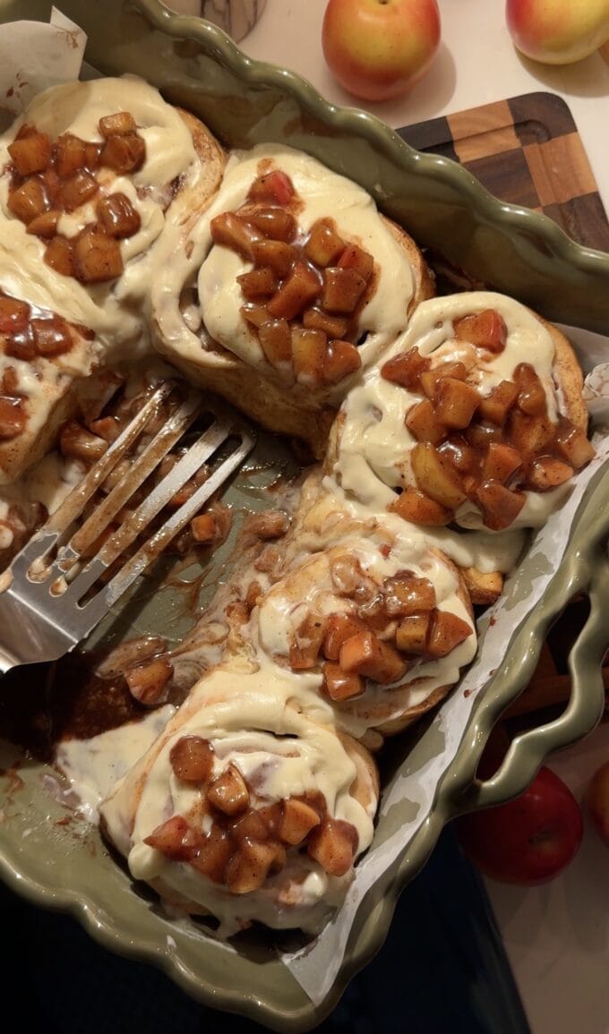 spatula in pan with apple cinnamon rolls