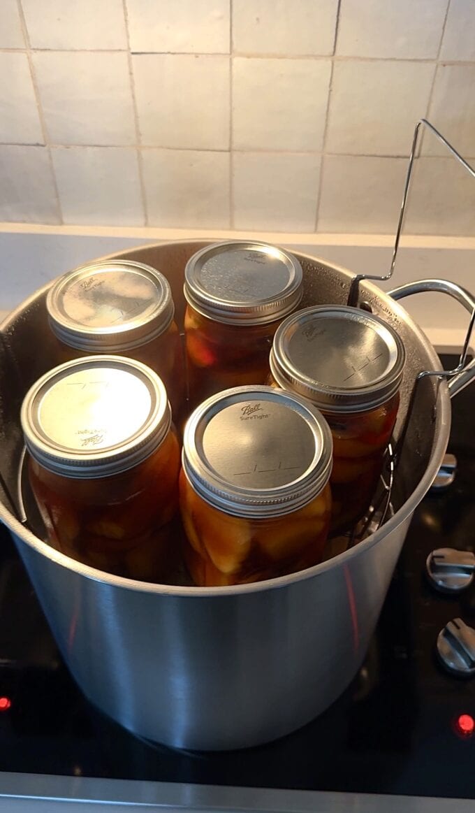 canned sweet tea peaches in canning pot