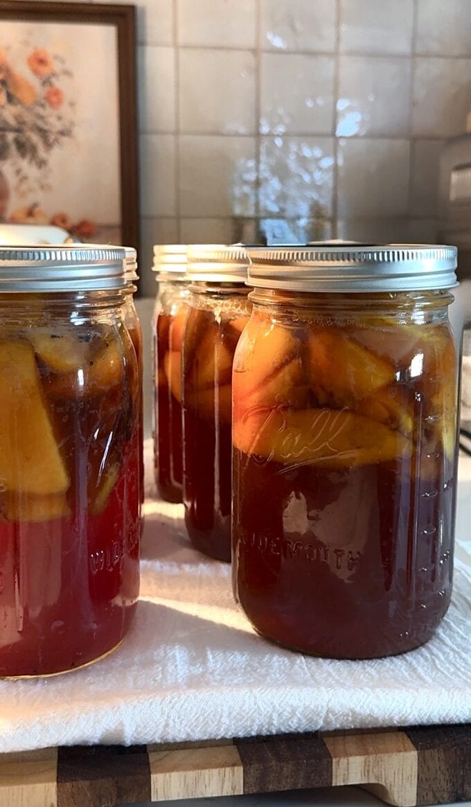 canned sweet tea peaches on kitchen towel