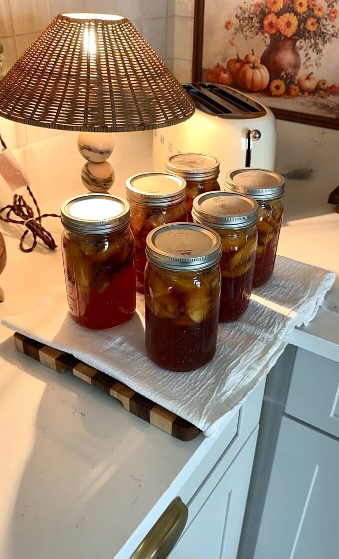 canned sweet tea peaches in jars on linen towel