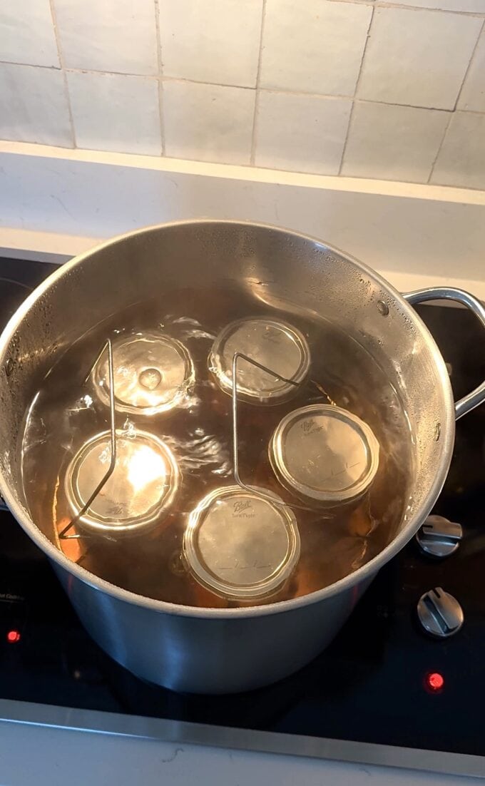 canned sweet tea peaches boiling in canning pot